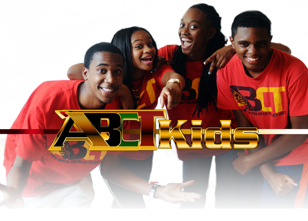 Four people smiling and posing in front of a backdrop with "ABCIT Kids" logo.