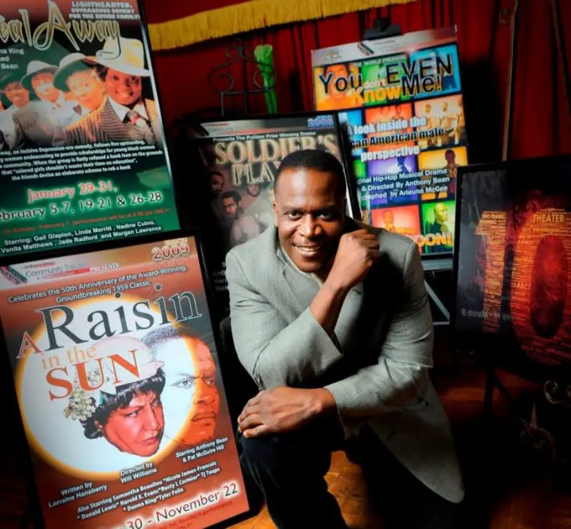 A man sitting in front of several magazines.