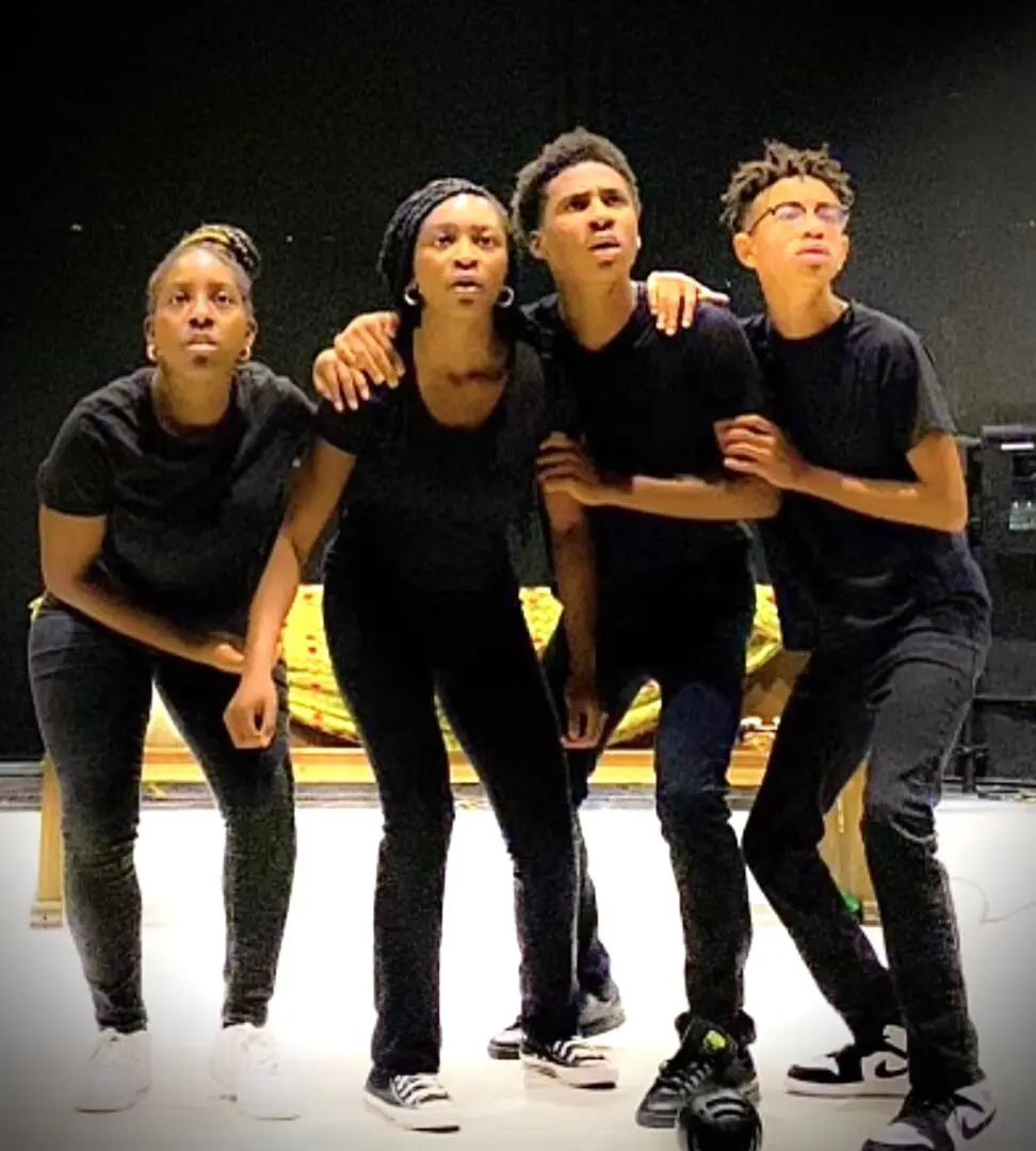 A group of people standing on top of a stage.