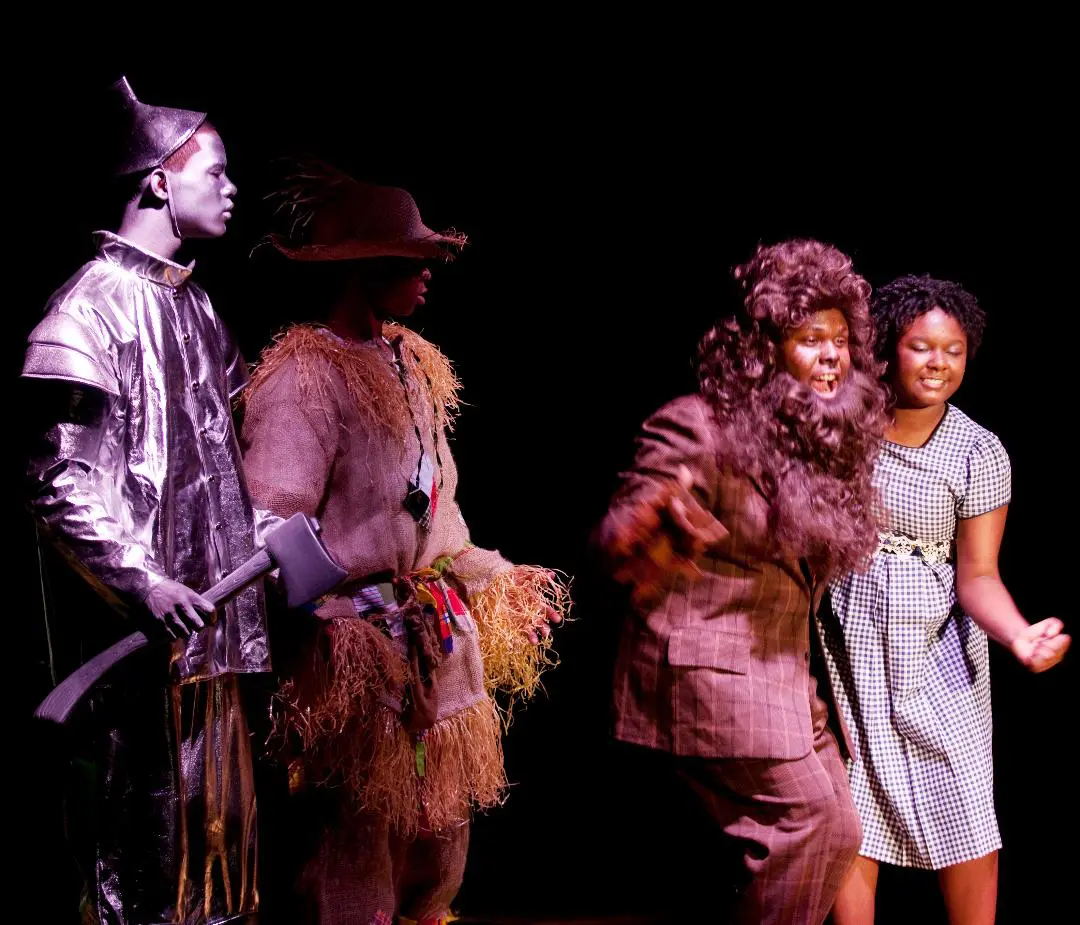 A group of people standing on stage in costumes.