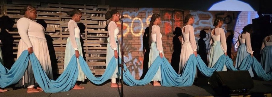 Praise dancers in white and blue holding a long blue cloth