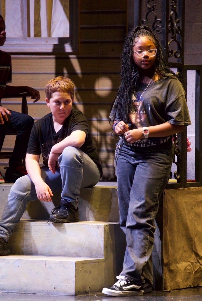 Two young actors on the steps of the set