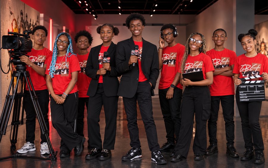 ABCT Teen Talk TV teen hosts and crew in red ABCT shirts with a TV camera and microphones